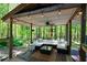 Comfortable outdoor lounge with stylish seating, ceiling fan, and ambient lighting for a relaxing entertainment space at 247 Shallowford Nw Rd, Kennesaw, GA 30144