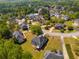 Aerial view of a residential neighborhood with well-maintained homes, mature trees, and lush green lawns at 4828 Planters Walk, Douglasville, GA 30135