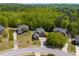 An aerial view of a neighborhood with mature trees, well manicured lawns, and various home styles at 4828 Planters Walk, Douglasville, GA 30135