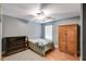 Well-lit bedroom has hardwood floors, ceiling fan, large dresser, and closet at 4828 Planters Walk, Douglasville, GA 30135