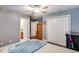 Spacious bedroom features ensuite bath, ceiling fan, and double-door closet at 4828 Planters Walk, Douglasville, GA 30135