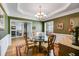 Traditional dining room with hardwood floors, decorative wallpaper, and glass table with seating for four at 4828 Planters Walk, Douglasville, GA 30135