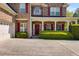 Attractive two story brick home with red shutters, covered porch, and attached two-car garage at 4828 Planters Walk, Douglasville, GA 30135