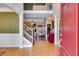 Open foyer with hardwood floors, staircase with wrought iron railing, and view into the living room at 4828 Planters Walk, Douglasville, GA 30135