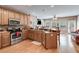 Functional kitchen with stainless steel appliances, wood cabinets, and island with bar stools at 4828 Planters Walk, Douglasville, GA 30135