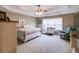 Large main bedroom with tray ceiling, carpeted floors, and a cozy sitting area at 4828 Planters Walk, Douglasville, GA 30135