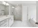 Modern bathroom with a glass shower enclosure and a separate soaking tub at 5817 Creek Indian Dr, Sugar Hill, GA 30518