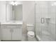 Stylish bathroom with white vanity, modern mirror, and a glass-enclosed tiled shower at 5817 Creek Indian Dr, Sugar Hill, GA 30518