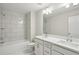 Modern bathroom featuring a shower/tub combo and double sink vanity at 5817 Creek Indian Dr, Sugar Hill, GA 30518