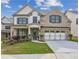 Charming two-story home with brick facade, neat landscaping, and a welcoming front porch at 5817 Creek Indian Dr, Sugar Hill, GA 30518