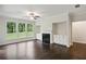 Cozy living room with fireplace, custom built-ins, hardwood floors, and bright windows at 5817 Creek Indian Dr, Sugar Hill, GA 30518