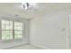 Bright room featuring a ceiling fan and large windows showcasing the outdoor view at 6125 Brookechase Ln, Norcross, GA 30093