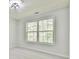 Bright room featuring a ceiling fan and large windows showcasing the outdoor view at 6125 Brookechase Ln, Norcross, GA 30093