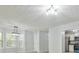 Inviting dining area with large windows and modern lighting, next to kitchen at 6125 Brookechase Ln, Norcross, GA 30093