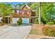 Charming two-story brick home with red shutters, a well-manicured lawn, and a two-car garage at 6125 Brookechase Ln, Norcross, GA 30093