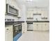 Efficient kitchen with sleek, modern appliances, neutral cabinets, and black granite countertops at 6125 Brookechase Ln, Norcross, GA 30093