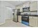 Kitchen showing stainless steel appliances, wooden cabinets, and bright, modern flooring at 6125 Brookechase Ln, Norcross, GA 30093