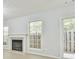 Bright room with fireplace, window, and sliding glass door to patio at 6125 Brookechase Ln, Norcross, GA 30093