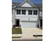 Charming townhome with a two-car garage and a manicured front lawn, creating an inviting curb appeal at 6425 Rosetta Drive, Unit 65, South Fulton, GA 30331