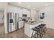 Bright kitchen features white cabinets, granite countertops, stainless steel appliances, and a convenient breakfast bar at 6425 Rosetta Drive, Unit 65, South Fulton, GA 30331