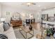 Open concept living room with bright light, modern decor, wood-look floors, and seamless flow to the kitchen at 6425 Rosetta Drive, Unit 65, South Fulton, GA 30331