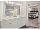 Bright bathroom with dual sinks, white cabinetry, and a large mirror, creating a functional and stylish space at 6425 Rosetta Drive, Unit 65, South Fulton, GA 30331