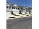 A row of newly constructed townhomes, each featuring individual garages and coordinated architectural styles at 6425 Rosetta Drive, Unit 65, South Fulton, GA 30331