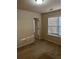 Bright bedroom featuring a window that offers natural light and a view and a spacious closet at 893 Port West Dr, Auburn, GA 30011