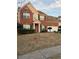 Charming two-story brick home featuring a manicured lawn and a welcoming entrance at 893 Port West Dr, Auburn, GA 30011