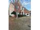 Charming two-story brick home featuring a manicured lawn and a welcoming entrance at 893 Port West Dr, Auburn, GA 30011
