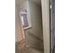 Hallway leading to a bedroom featuring a window, enhancing natural light and a sense of spaciousness at 893 Port West Dr, Auburn, GA 30011