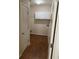 Bright laundry room featuring white cabinets and wood-look flooring at 893 Port West Dr, Auburn, GA 30011