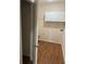 Bright laundry room featuring white cabinets and wood-look flooring at 893 Port West Dr, Auburn, GA 30011