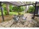 Outdoor patio area with stone pavers and plenty of room for seating with a covered pergola at 126 N Barton St, Norcross, GA 30071