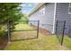 View of the chain link fence enclosing the backyard, with a glimpse of the home's exterior siding at 126 N Barton St, Norcross, GA 30071