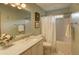 Clean bathroom featuring a shower/tub combo, updated vanity, and a decorative framed mirror at 126 N Barton St, Norcross, GA 30071
