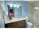 Bathroom with stone tile shower, granite countertop vanity, and blue walls at 126 N Barton St, Norcross, GA 30071