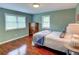 Comfortable bedroom featuring hardwood floors, fresh paint, light, and a large window for natural light at 126 N Barton St, Norcross, GA 30071
