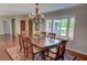 Formal dining room with large window, chandelier, hardwood floors, and area rug at 126 N Barton St, Norcross, GA 30071