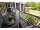 Inviting front porch featuring a seating area with a small table and wicker chairs at 126 N Barton St, Norcross, GA 30071