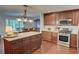 Spacious kitchen featuring wooden cabinets, granite countertops, a kitchen island and stainless steel appliances at 126 N Barton St, Norcross, GA 30071
