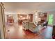 Spacious open-concept living room with fireplace, hardwood floors, and a view of the dining area and kitchen at 126 N Barton St, Norcross, GA 30071