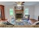 Inviting living room area with a stone fireplace, comfortable seating, and hardwood floors at 126 N Barton St, Norcross, GA 30071