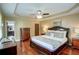 Main bedroom with hardwood floors, trey ceilings, and view to bathroom at 126 N Barton St, Norcross, GA 30071