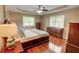 Bedroom with hardwood floors, trey ceilings, two windows and a collection of wooden furniture at 126 N Barton St, Norcross, GA 30071