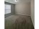Empty bedroom featuring neutral paint, plush carpet, a window, and ample space for furniture at 4291 Preserve Trl, Snellville, GA 30039