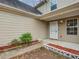 Inviting front porch area featuring brick-lined flower beds and a well-lit entrance at 1526 Venetian Sw Dr, Atlanta, GA 30311