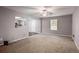 Bright living room featuring neutral carpet, soft gray walls and a ceiling fan at 1526 Venetian Sw Dr, Atlanta, GA 30311