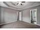 Spacious main bedroom with a tray ceiling, walk-in closets, and an en-suite bathroom at 1526 Venetian Sw Dr, Atlanta, GA 30311