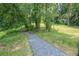 Gravel path leading through a lush, green backyard, offering a sense of outdoor adventure at 2557 Avery Park Cir, Atlanta, GA 30360